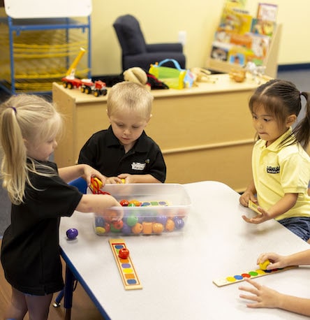Preschool children using curriculum based toys to learn.