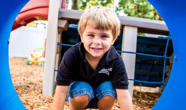Before and After School Daycare Student playing on our playground.