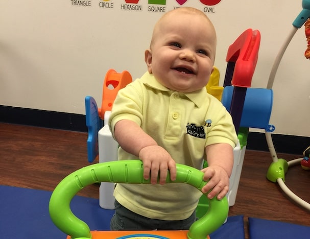 Infant daycare center child learning to walk.